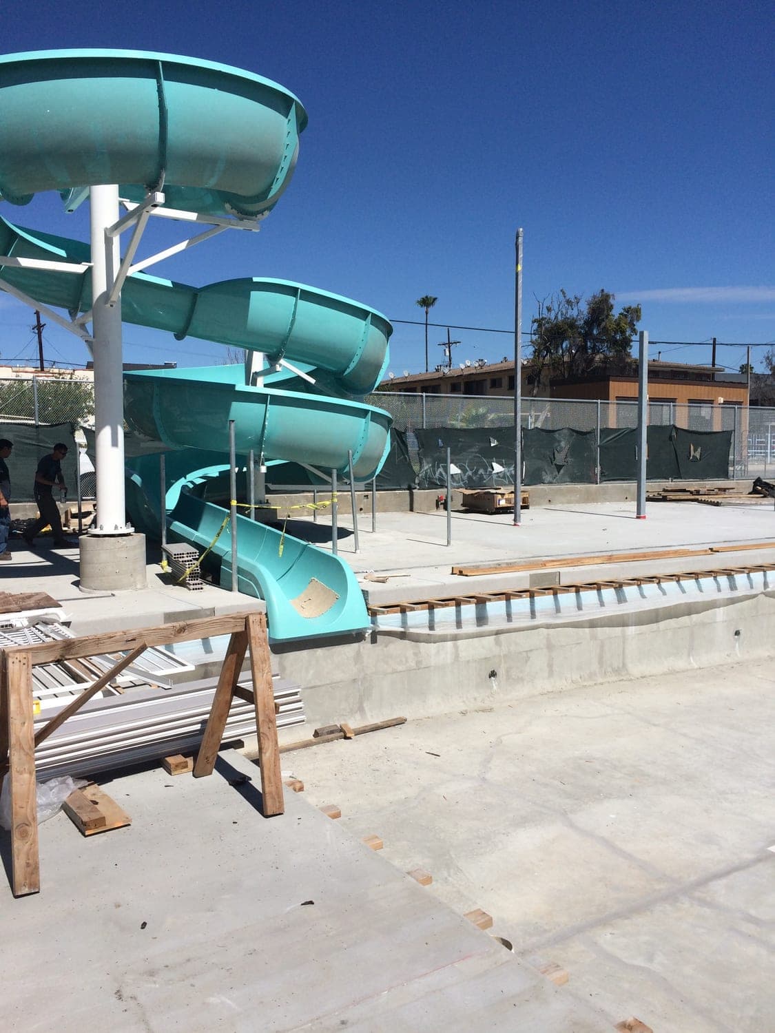 Bank of fiberglass water slides on structural steel supports at the aquatic facility