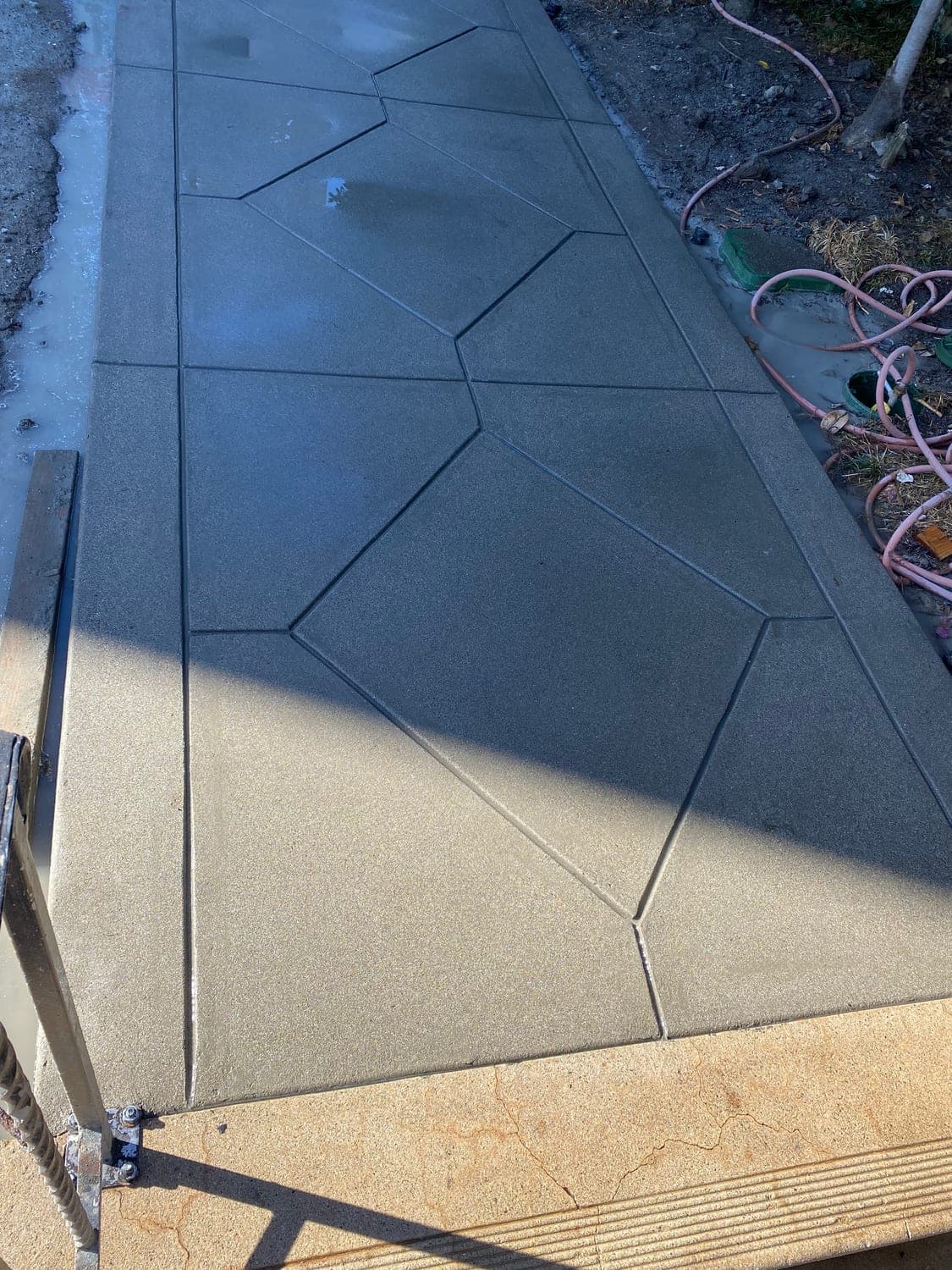 Scored-concrete walkway with geometric saw-cut detailing