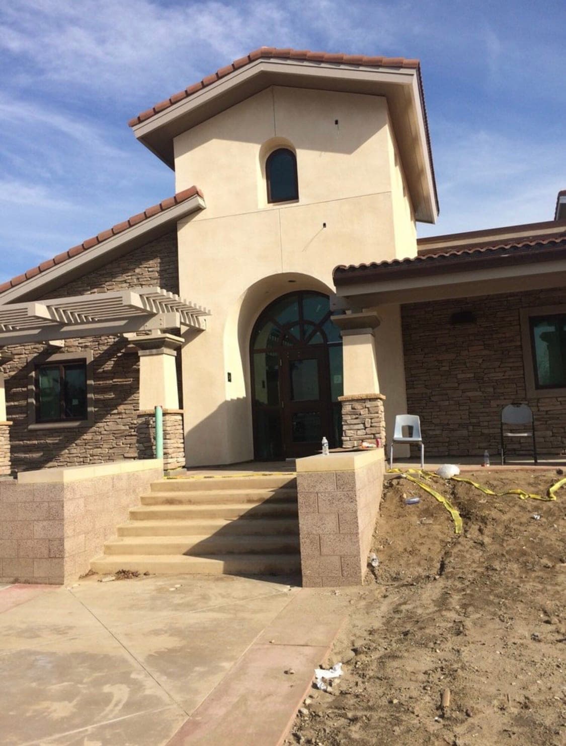 Finished Mediterranean-style commercial building with corner tower and arched entry