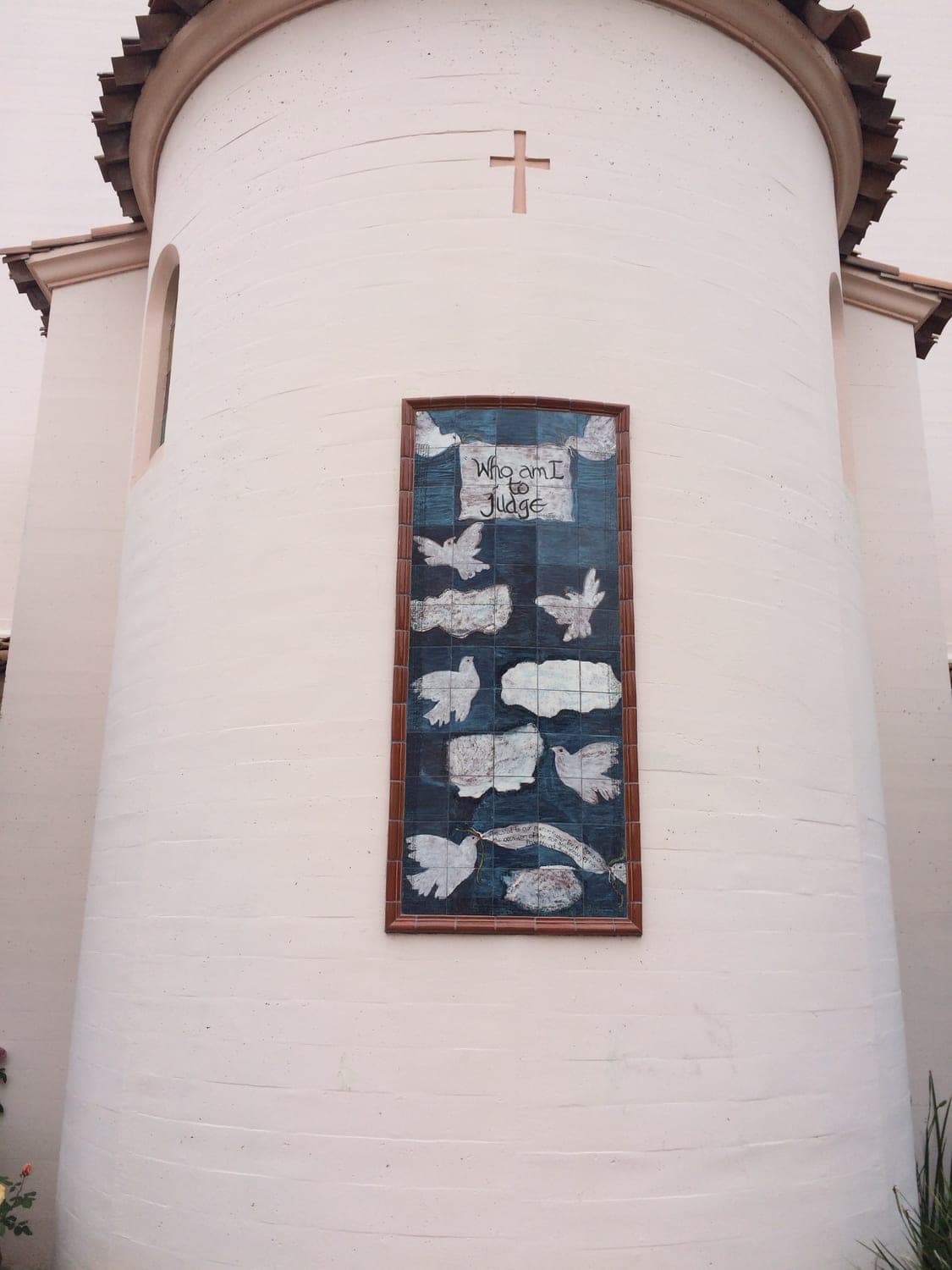 Hand-finished stucco chapel with custom framed ceramic-tile mural and cross